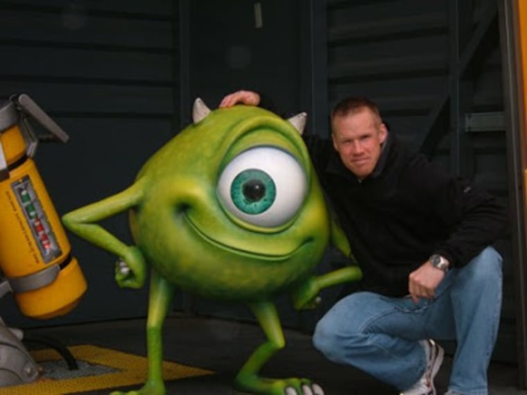 Charlie Bailey poses with the Mike Wazowski statue at Disneyland Paris in 2008.