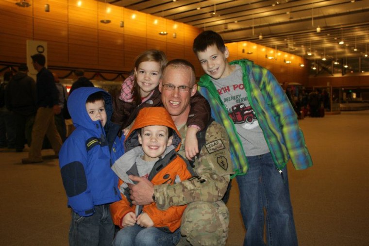 The Bailey children greet Charlie at the airport during his mid-tour leave from Afghanistan several days before Christmas in 2011.