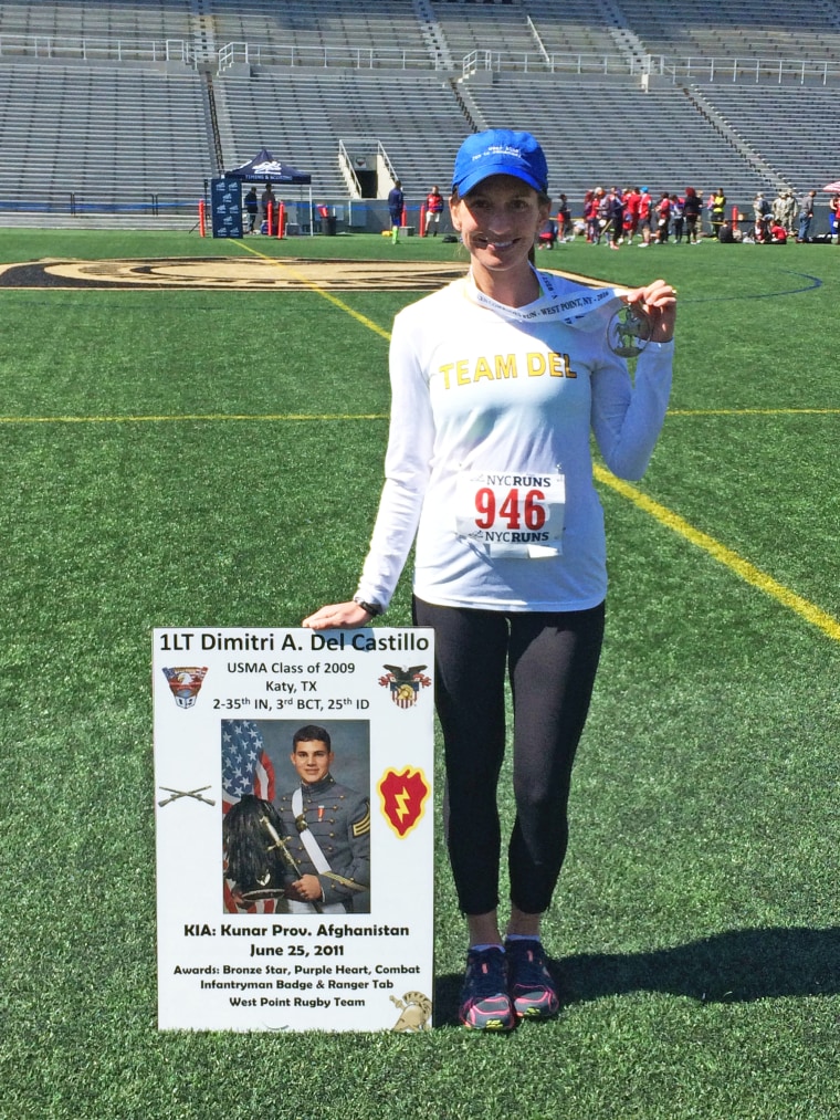 Katie Vail with Dimitri del Castillo's memorial sign at the Fallen Comrades Half Marathon in West Point, New York.