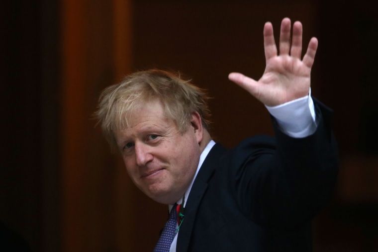 Image: Britain's Prime Minister Boris Johnson waves on the steps of Downing street in central London