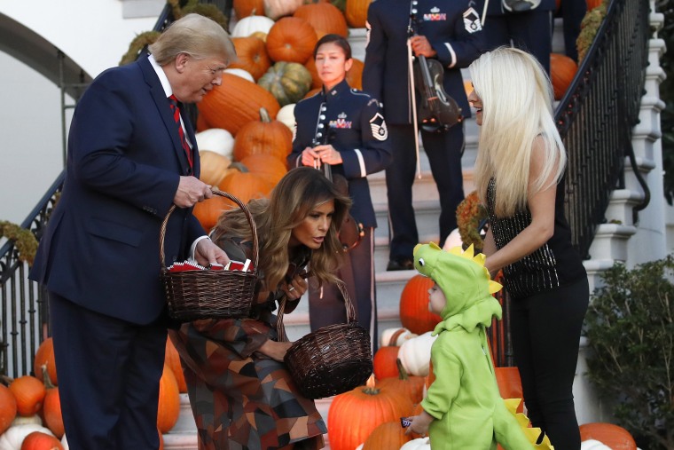 Image: President Donald Trump and first lady Melania Trump give candy to children during a Halloween trick-or-treat event on the South Lawn of the White House which is decorated for Halloween