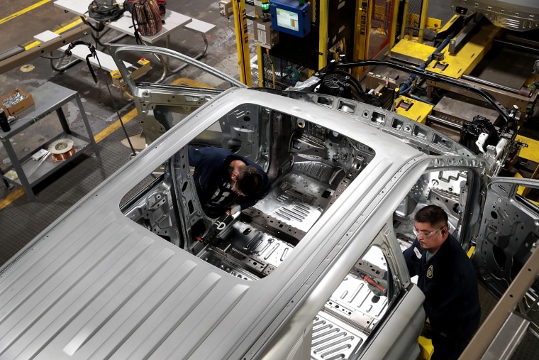 Image: Workers assemble Ford vehicles at an assembly plant in Chicago on June 24, 2019.