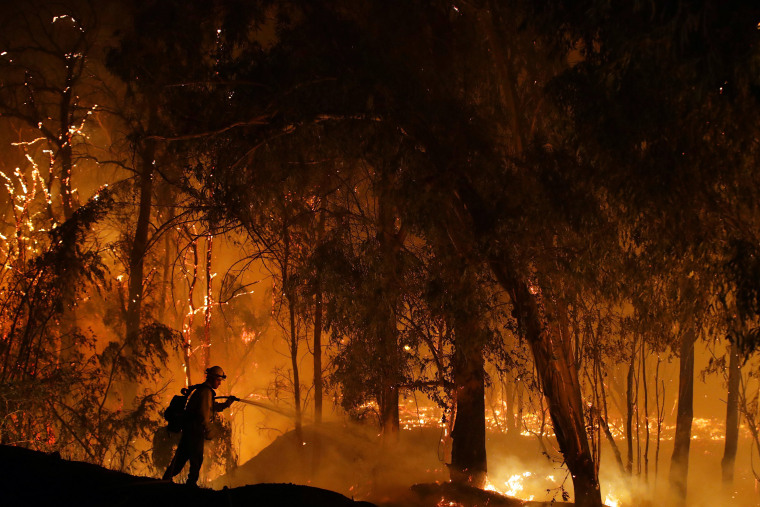 Image: A firefighter battles the Maria Fire Thursday, Oct. 31 2019, in Somis, Calif