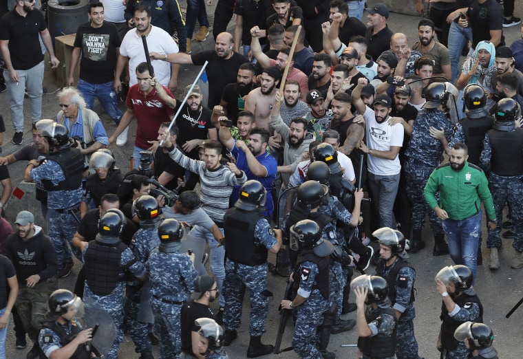 Image: Riot police try to stop Hezbollah supporters 