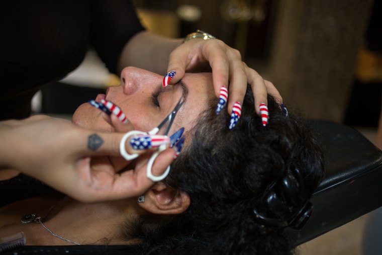 Soudabeh Sabour has her eyebrows plucked at a beauty salon run by one of her students Oct. 8, 2014.