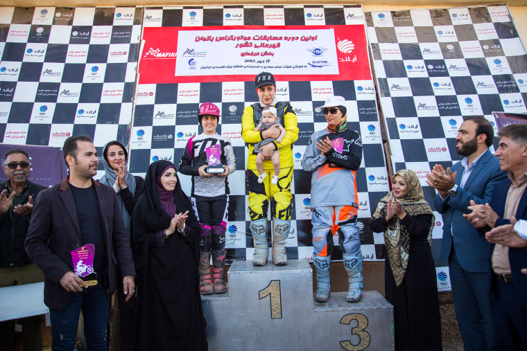 Jabbari holds her infant daughter, Hanna, before receiving the gold medal at the Iranian Women's Motocross Championship in Tehran Oct. 11, 2019.