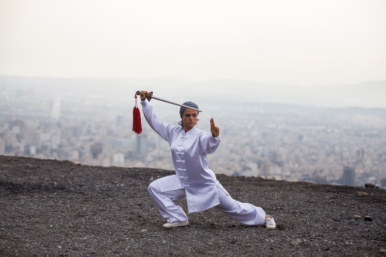 Parisa Mihan Doost warms up with a sword before the start of a tai chi class she teaches in Tehran on Oct. 13, 2018.