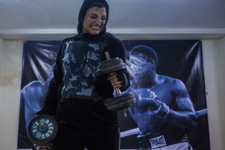 Sadaf Khadem lifts weights at her gym in Varamin, a small town outside Tehran on Jan. 4, 2017.