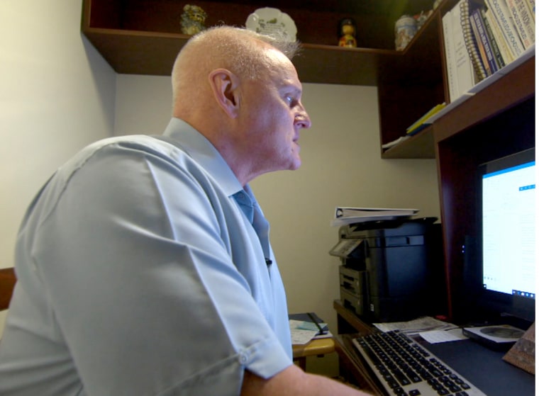 Lt. Col. Ted Blickwedel working at his computer in his home office in Rhode Island.