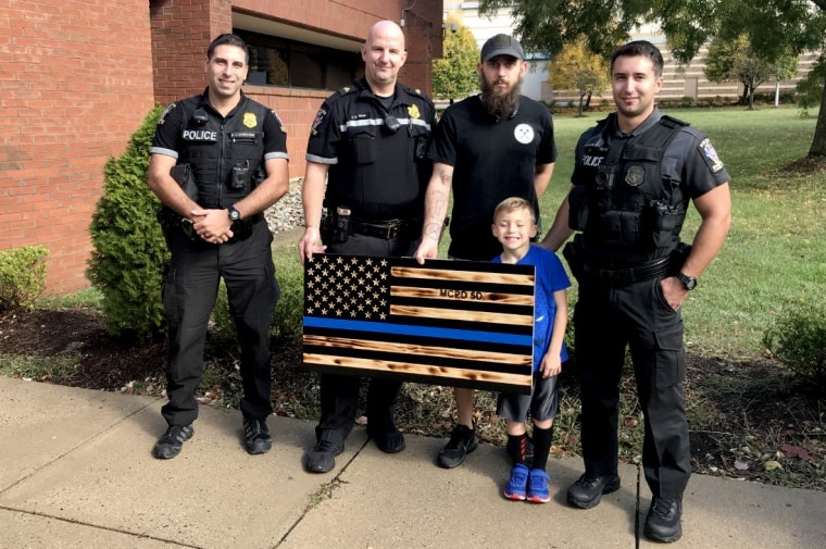 Image: James Shelton presented the Montgomery County Department of Police with a wooden American flag.