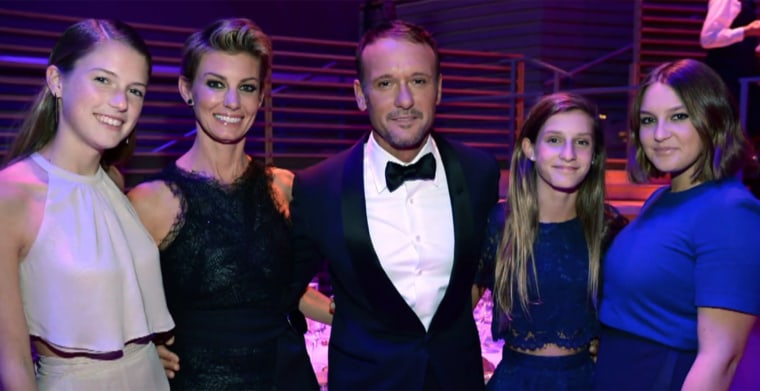 Tim McGraw and Faith Hill pose with their daughters in 2015. 