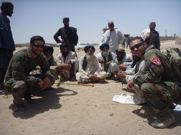 U.S. Marine Special Operations Team commander Derek Herrera, far left, is shown meeting with Afghan locals and building a working relationship with Afghan elders in 2012.