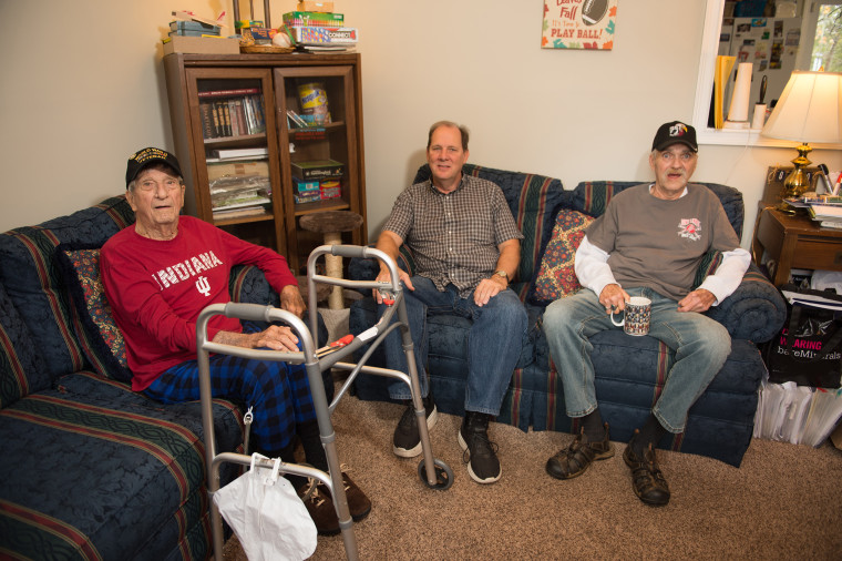 World War II veteran Norman Miller, foster home caregiver Barney Musselman and Vietnam veteran Carroll Botts spend time together in the living room.