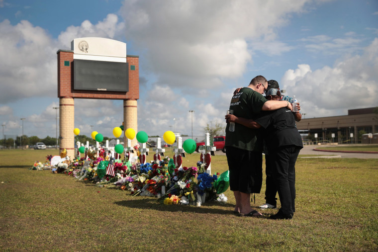 Image: Mourners pray at a memorial in front of Santa Fe High School