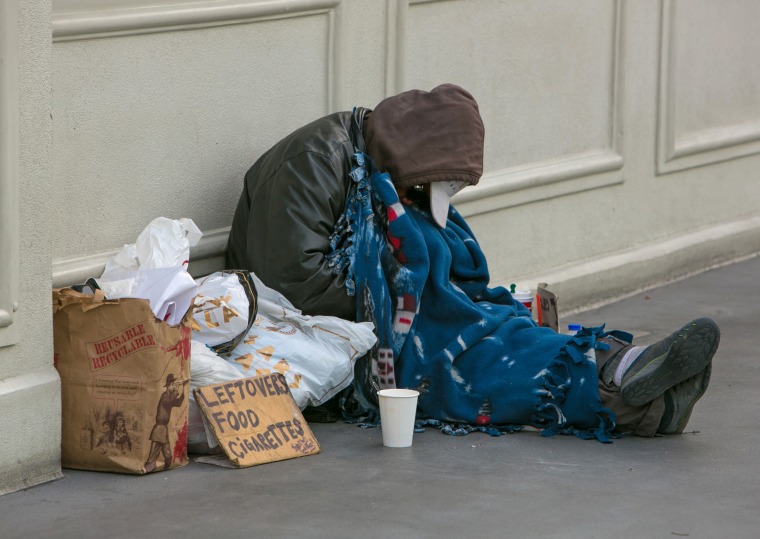 A homeless man sleeps on a pedestrian bridge in Las Vegas in 2015.