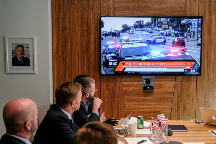 Images of an immersive simulation of mock news events are displayed during an election hacking \"tabletop\" exercise.
