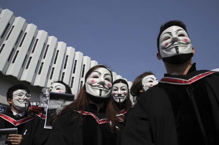 Image: University students wearing Guy Fawkes masks during a protest before their graduation ceremony at the Chinese University of Hong Kong