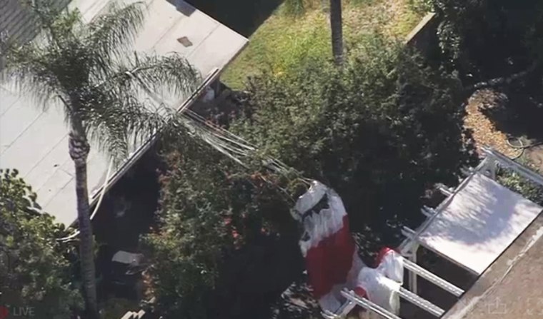A parachute is deployed at the scene of a plane crash in Upland, Calif.