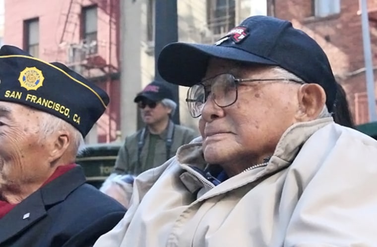 Randall Ching listens to the address with another Chinese American veteran of World War II.