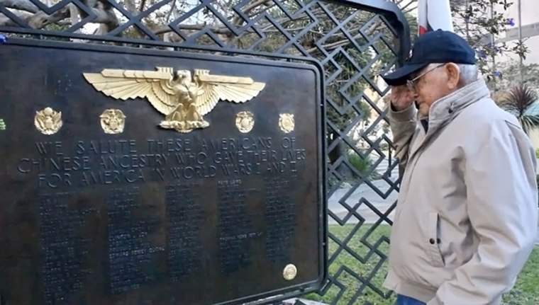 Randall Ching salutes the Chinese American World War I and World War II memorial at Saint Mary's Square Park in the Chinatown neighborhood of San Francisco.
