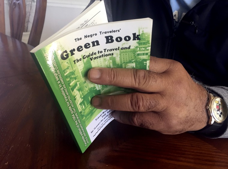 Image: Charles Becknell, Sr., holds a 1954 edition copy of \"The Negro Motorist Green Book\" at his home in New Mexico on Jan. 31, 2019.