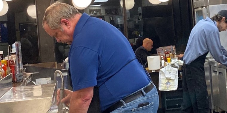 An unidentified customer was one of multiple people at an Alabama Waffle House who pitched in to help an overwhelmed cook who was stuck working by himself. 
