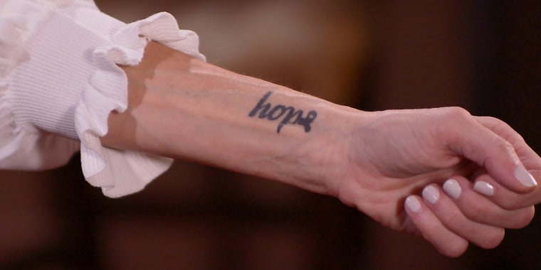 Feldman shows her "Hope" tattoo.