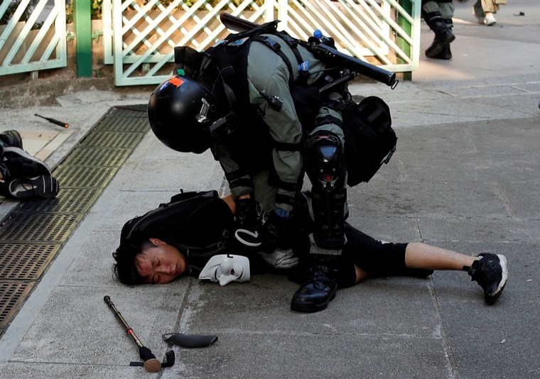 Image: Riot police detain protesters in Hong Kong