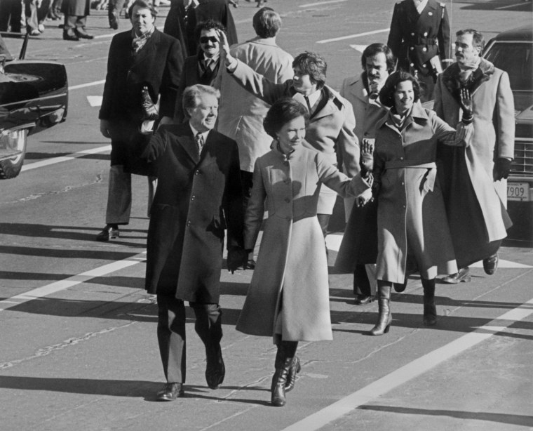 Image: Walking hand in hand, ex President Jimmy Carter ac