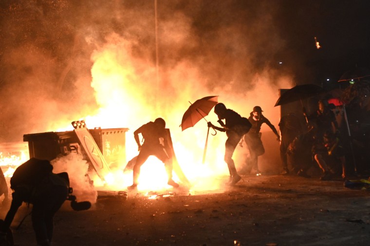 Protesters set up a fire during clashes with police at the Chinese University of Hong Kong (CUHK), in Hong Kong