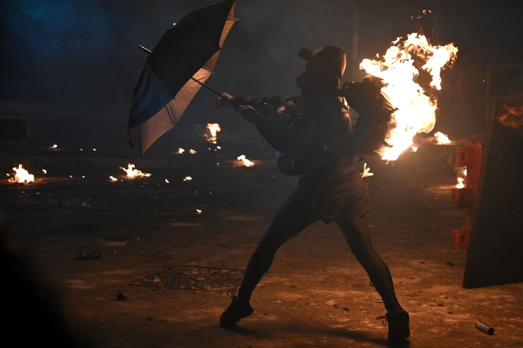 A protester's backpack is seen on fire during clashes with police at the Chinese University of Hong Kong (CUHK), in Hong Kong