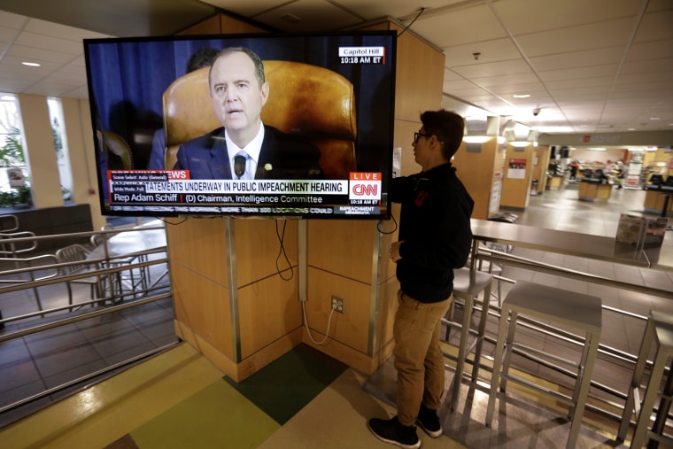 Image: University of Utah student Suyog Shrestha turns on a television at the school's student union as Rep. Adam Schiff speaks during an impeachment hearing on Nov. 13, 2019.