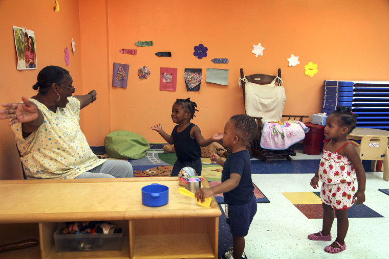 Image: "If you're happy and you know it, shout hooray!" sings Bobbye Barnes with the 2-year-olds at Uni-Pres Kindercottage in East St. Louis.
