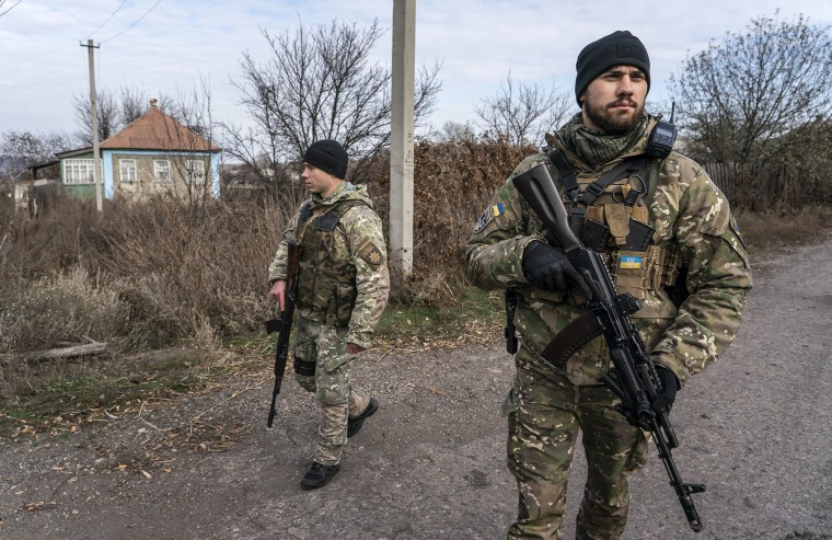 Image: Ukrainian policemen patrol a street near the new line of contact in Katerynivka, Luhansk region, eastern Ukraine