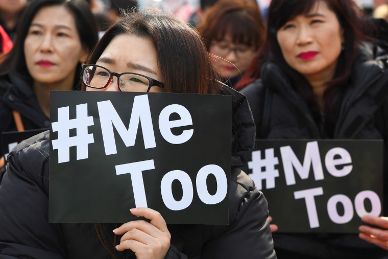 Image: South Korean demonstrators hold banners during a rally to mark International Women's Day as part of the country's #MeToo movement in Seoul