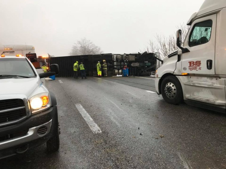 A tractor-trailer lost control and overturned on the eastbound lane.