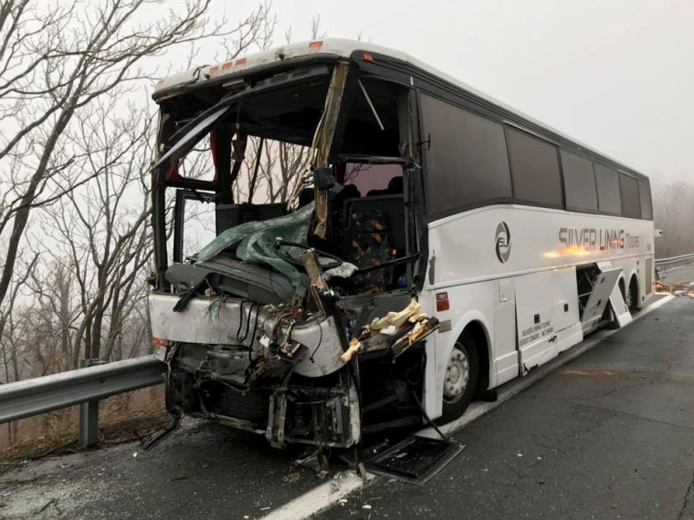 Image: A tour bus was unable to avoid the overturned tractor-trailer and hit it directly.