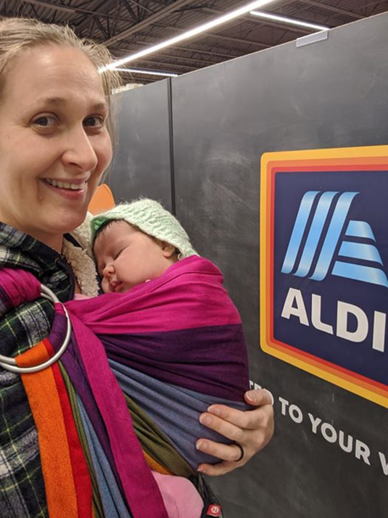 Patricia Larkin chuckled and posed in front of the Aldi sign after being accused of using a 'fake baby' to steal yogurt.