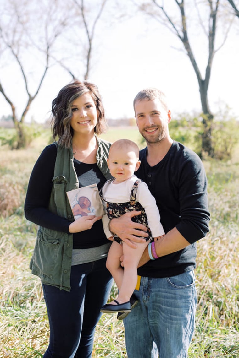 Strangfeld with her husband, Lee, their 18-month-old daughter, Porter, and a photo of baby Samuel.