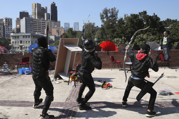 Image: Protesters prepare to shoot bows and arrows at Hong Kong Polytechnic University 