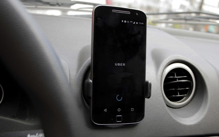 Image: A smartphone showing the Uber app is display inside a car in Brazil on May 2, 2017 in Belo Horizonte, Brazil.