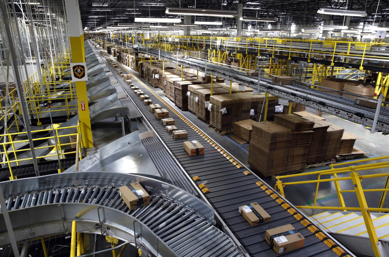 Packages ride on a conveyor system at an Amazon fulfillment center.