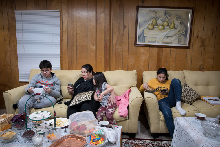 Dawut with her three children at home in northern Virginia, on Nov. 18, 2019.