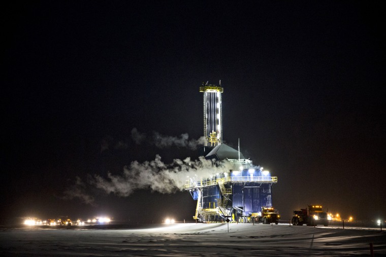 An oil drill rig is moved along a road in the North Slope in Prudhoe Bay, Alaska, in 2017.