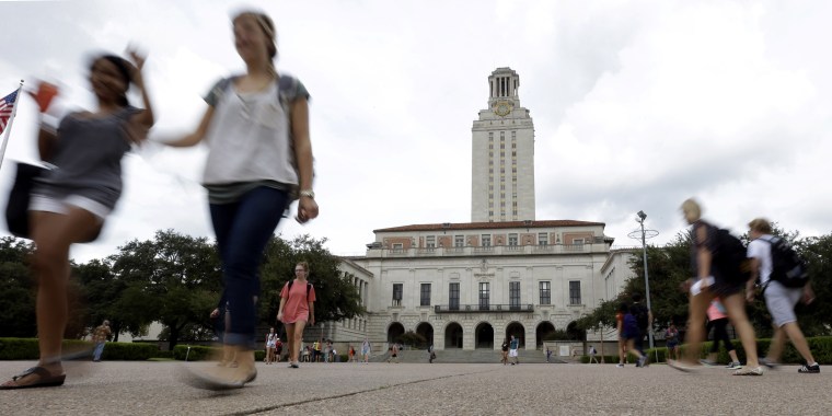 Students walk through the University of Texas at Austin campus near the school's iconic tower in 2012.