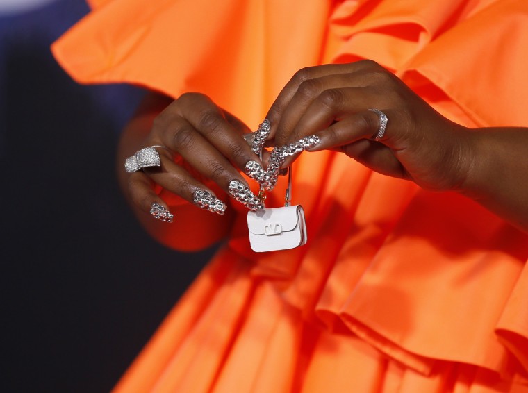 Lizzo serves retro vibes in tangerine as she carries the world's tiniest  purse at the AMAs in LA | Daily Mail Online