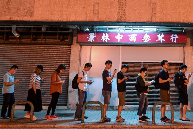 Image: People queue to cast their vote during the district council elections in Tseung Kwan O district in Hong Kong