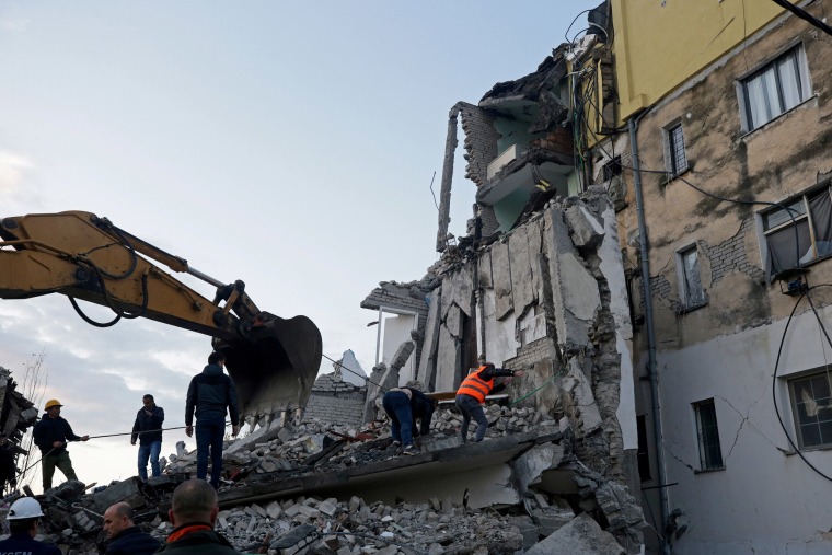 Image: Emergency personnel work near a damaged building in Thumane, after an earthquake shook Albania