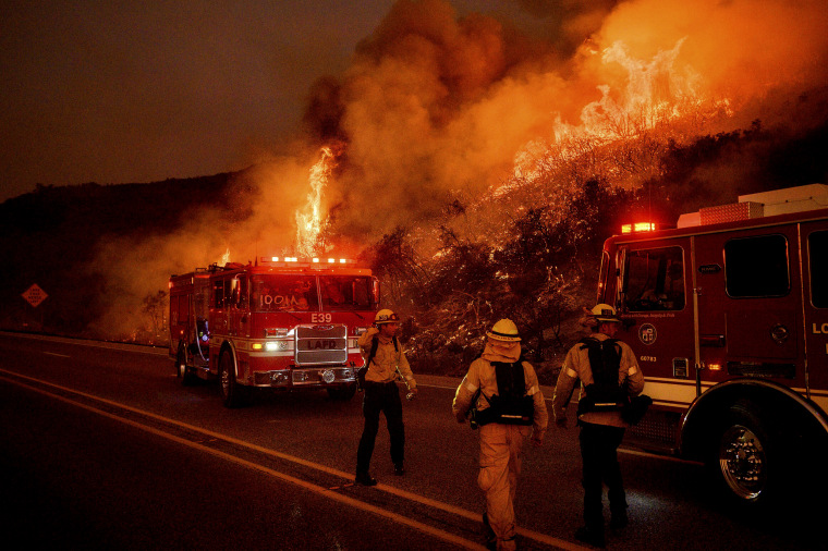 Image: Firefighters battle flames along Highway 154 near Santa Barbara, Calif., on Nov. 26, 2019.