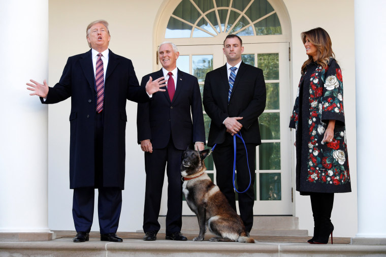Image: U.S. President Donald Trump speaks to the news media next to Vice President Mike Pence and Conan, the U.S. military dog that participated in and was injured in the U.S. raid in Syria that killed ISIS leader Abu Bakr al-Baghdadi